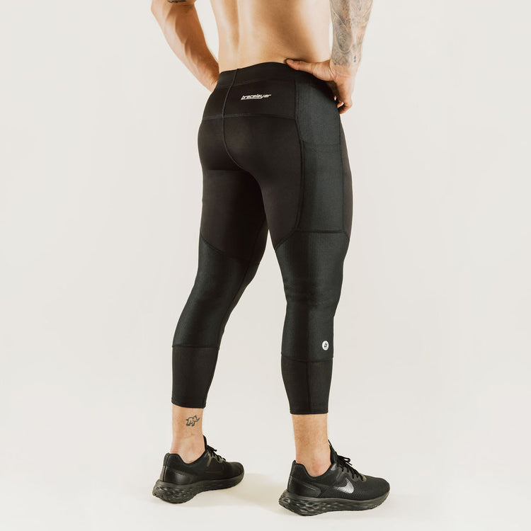 Men's low-rise black 7/8 compression pants with knee support panels and cuff hem