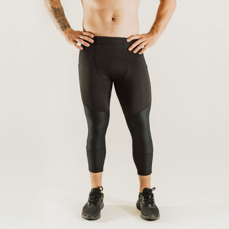 Men's low-rise black compression pants, 7/8 knee support, front view